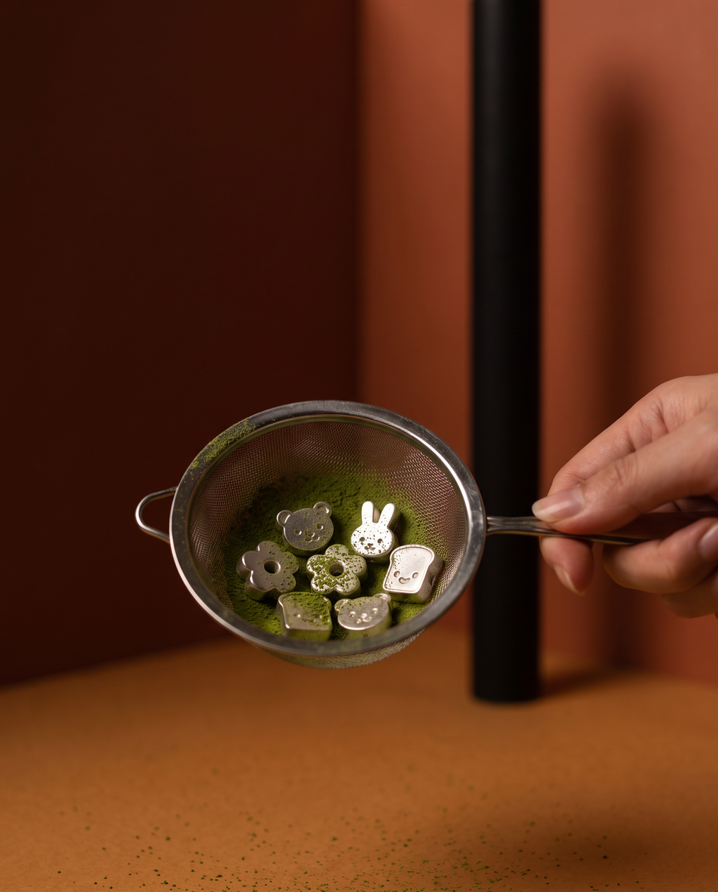 Beads in the sieve with matcha, top down